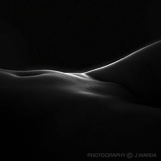 Low key silhuette of  a nude female body by j.warda the naked pixel fine art nude photography 